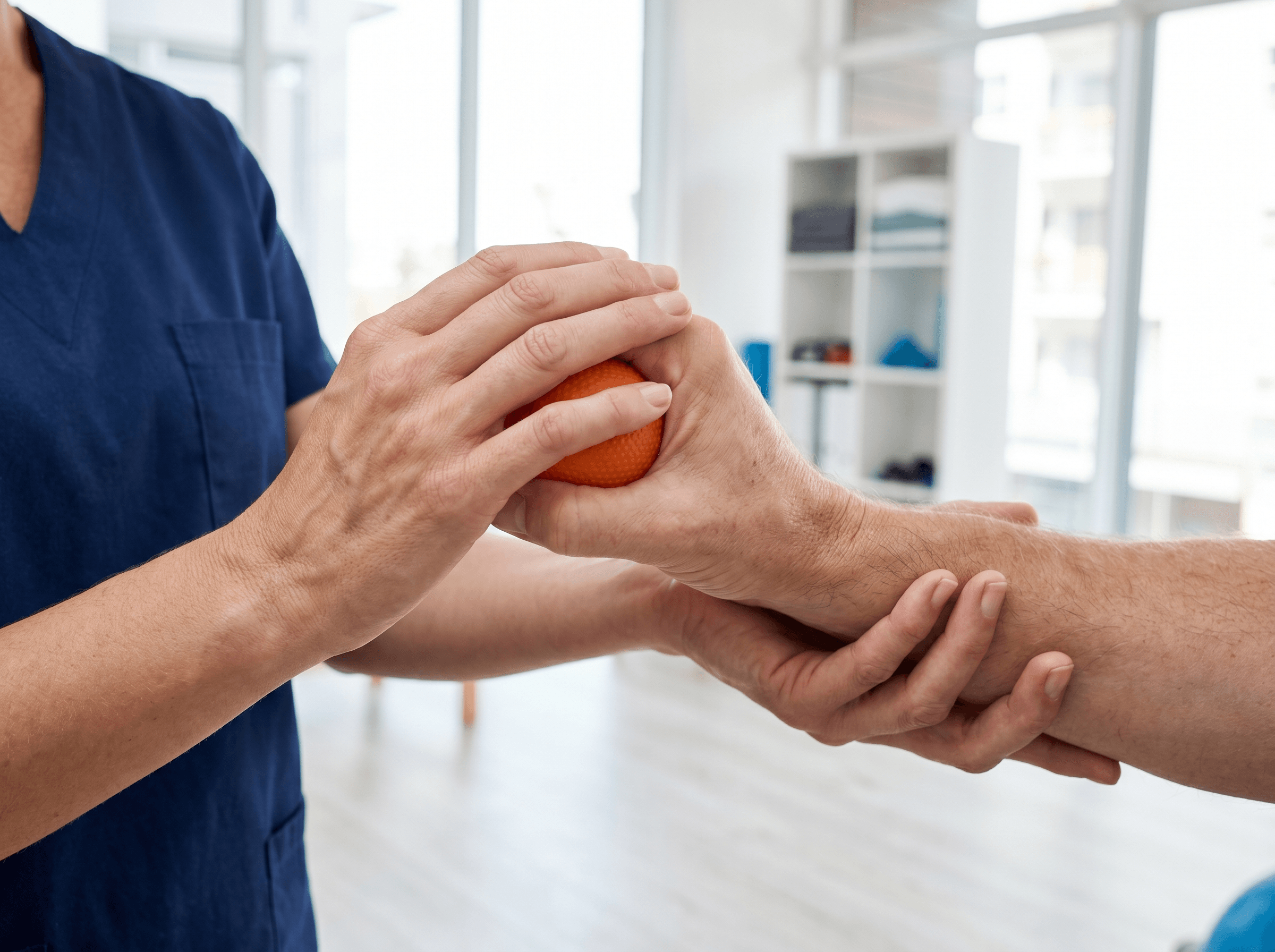 Patient squeezing an orange for a hand-grip exercise